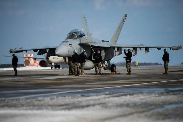 U.S. Navy Sailors assigned to the “Black Ravens” of Electronic Attack Squadron (VAQ) 135, perform maintenance on an EA-18G Growler after landing at Misawa Air Base, Japan, Jan. 11, 2021.