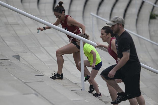 Contestants run up stadium bleachers during the Marine Corps Marathon (MCM)-hosted Run Amuck at Marine Corps Base Quantico, Va.