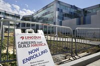 A sign rests near Lincoln Technical Institute in Somerville, Mass.